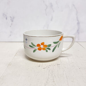 Fransk kaffekop med orange blomster